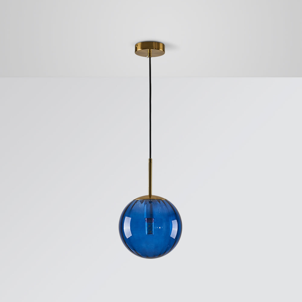 Blue transparent glass globe with an unlit bulb, gold-tone stem, round canopy and black cord against Gray