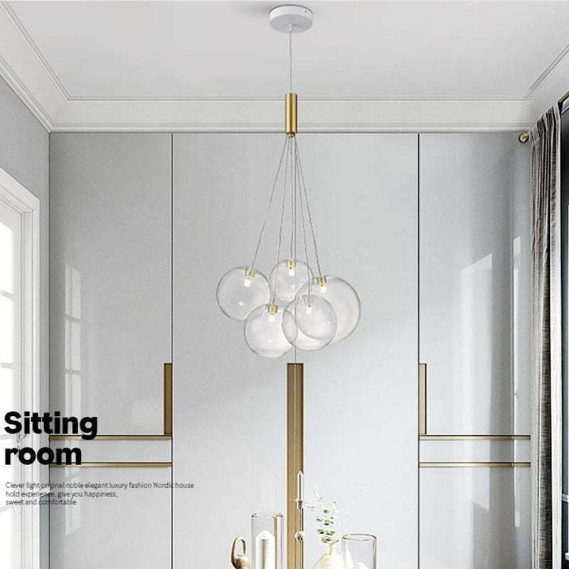 Valentina Transparent 5-bubble pendant with a white canopy and gold-tone fitting in a pale paneled room