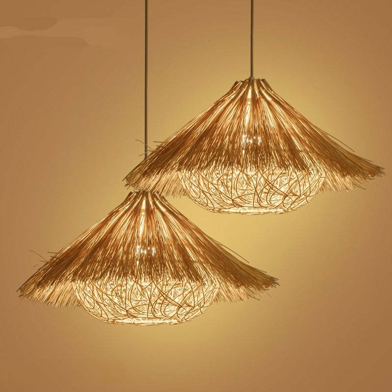 Two Muto rattan pendants displayed together at different heights against a warm wall.