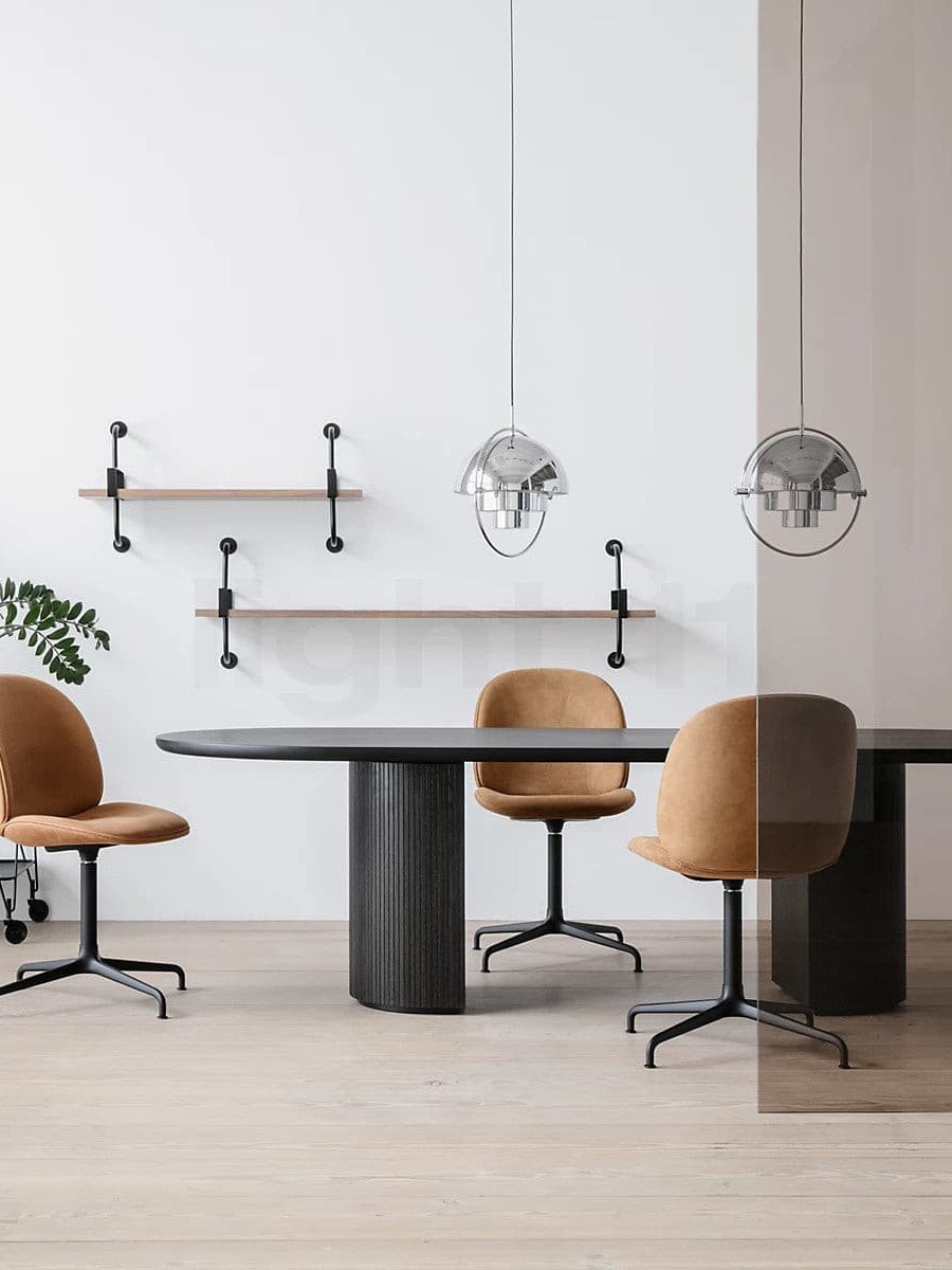 Two chrome-finish pendants above a dark office table