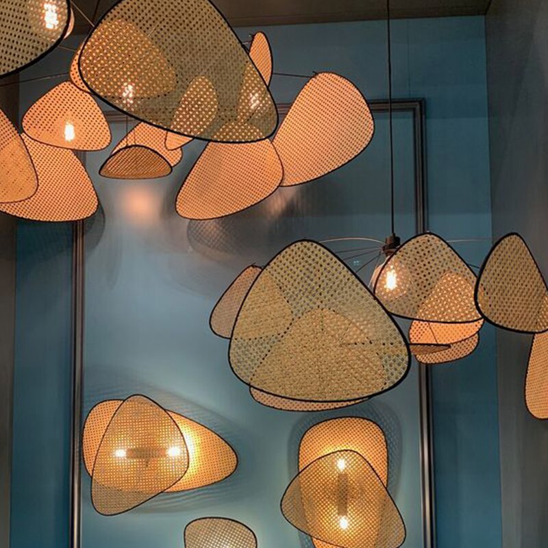 Several lit rattan leaf fixtures installed together in one room