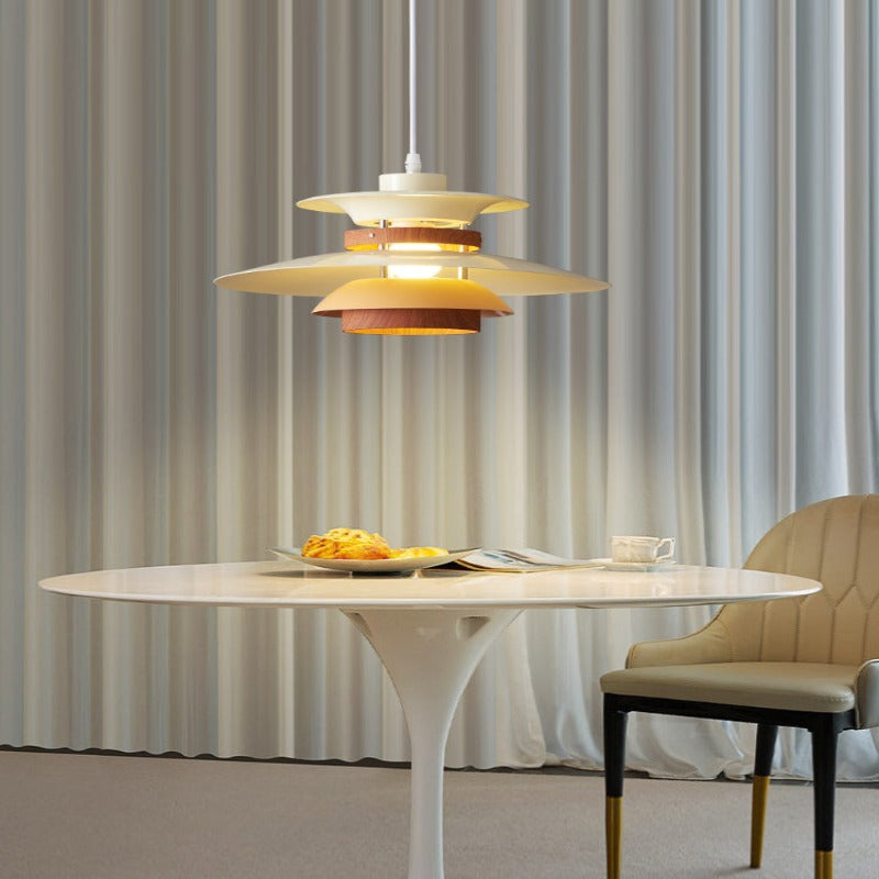 Lit single white tiered pendant over round table