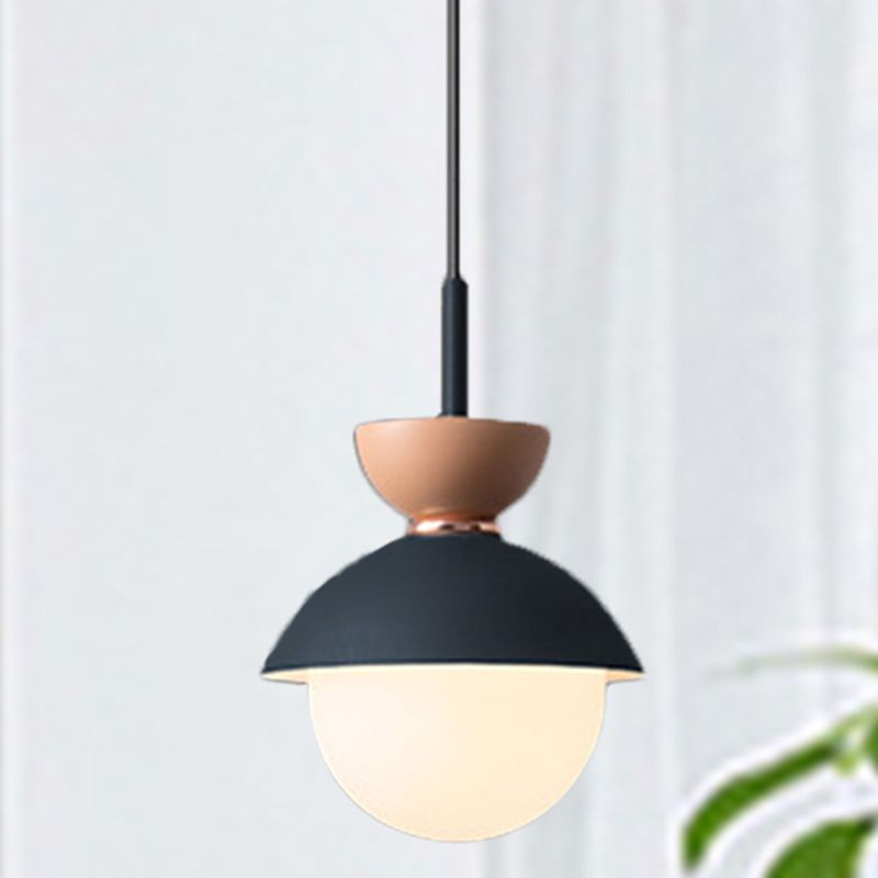 Morandi Navy pendant with pink upper cup and white globe beside a curtain