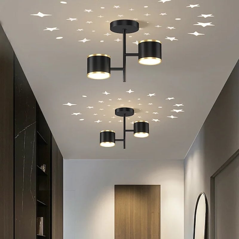 Black B-style cylinder ceiling lights above corridor star patterns