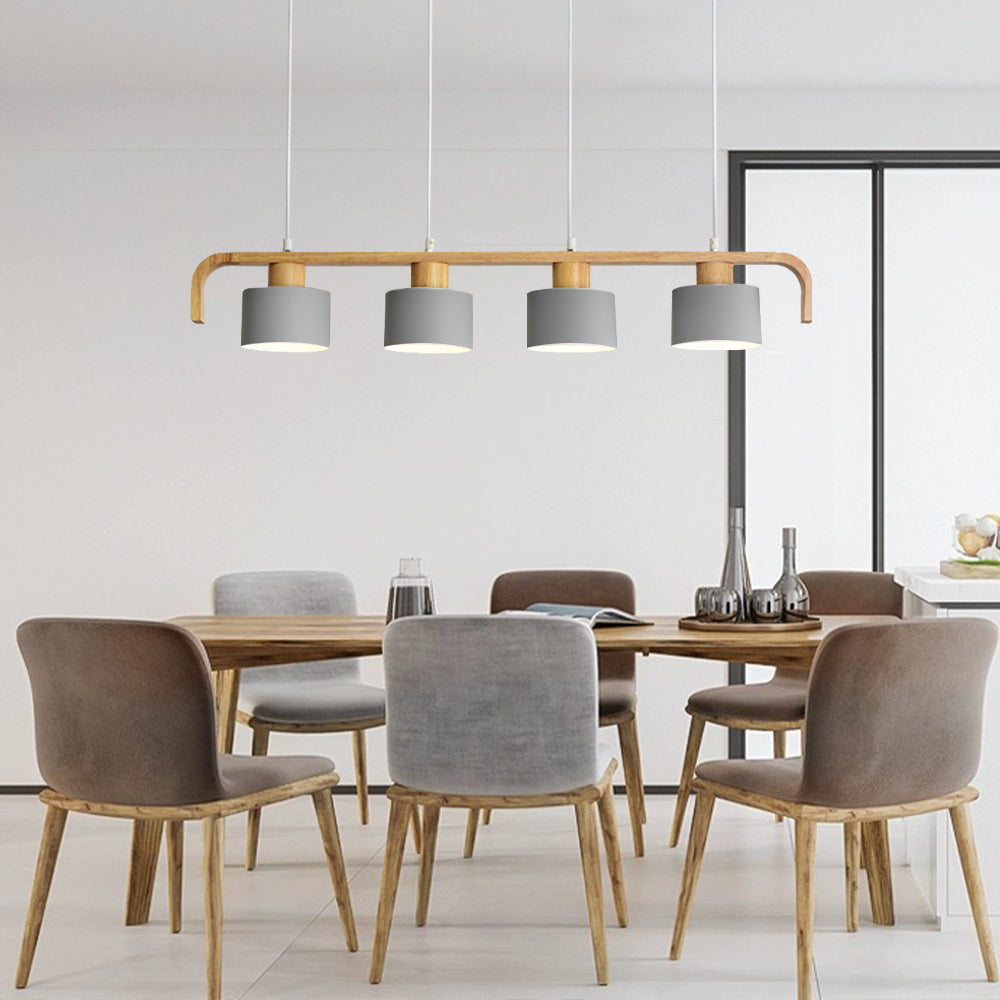 Four gray cylindrical shades on a wooden frame above a rectangular dining table with gray and taupe upholstered chairs