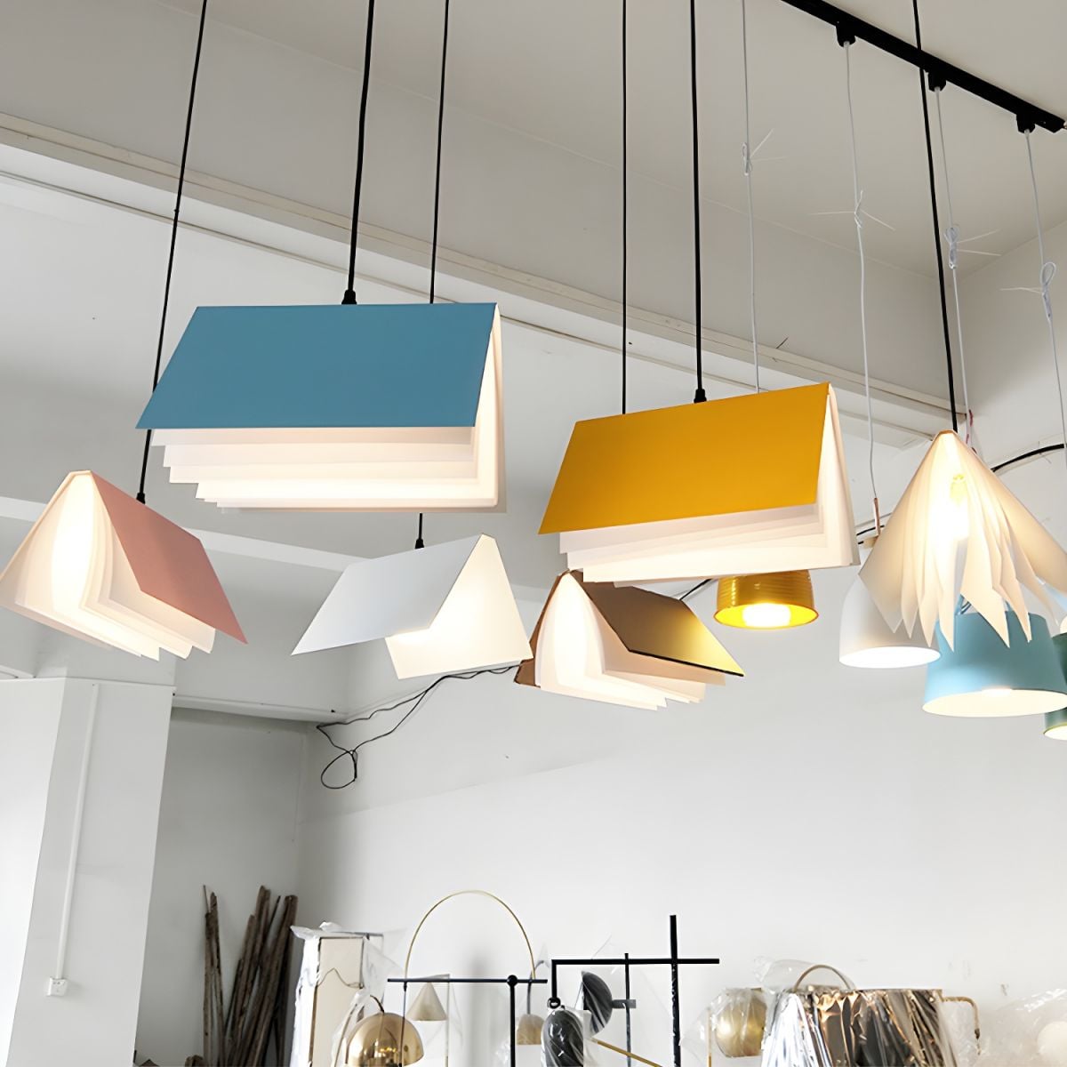 Multiple book pendants in different colours above a display