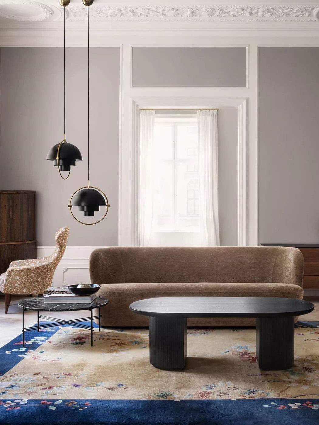 Two black pendants above a sofa and coffee table