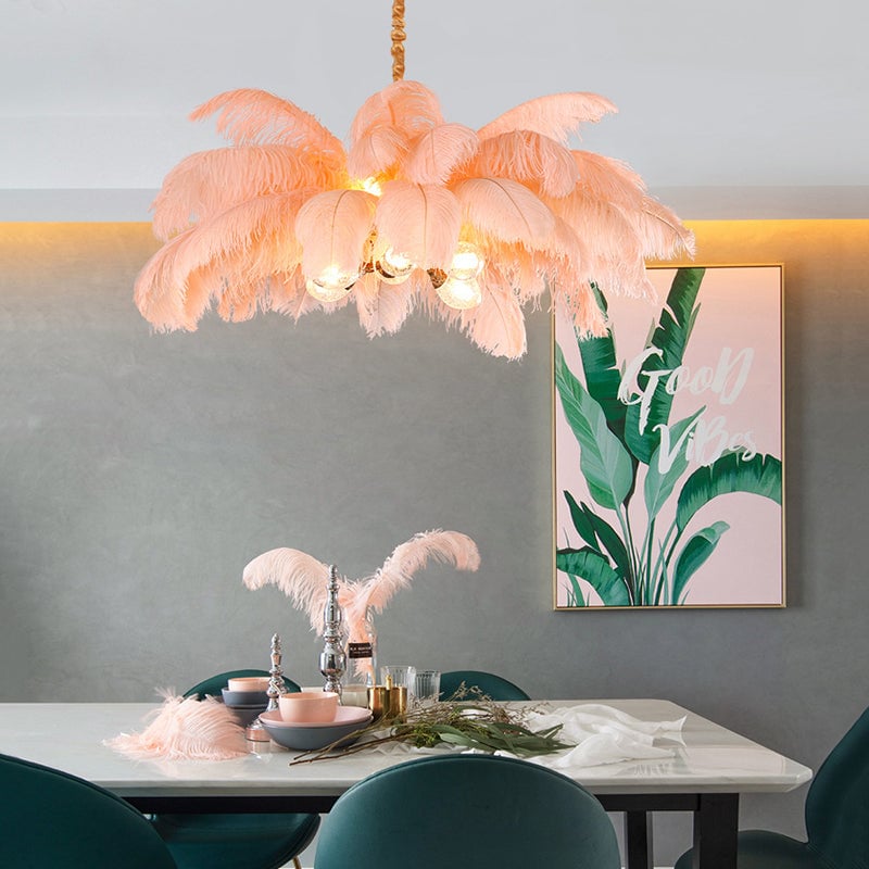 Pink O'Moore above marble-look dining table with green chairs, candlesticks and pink-and-green Good Vibes artwork
