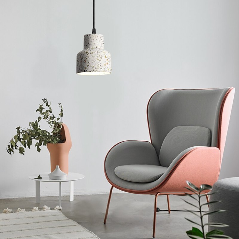 Stepped-neck speckled pendant beside a grey and pink lounge chair and white plant table
