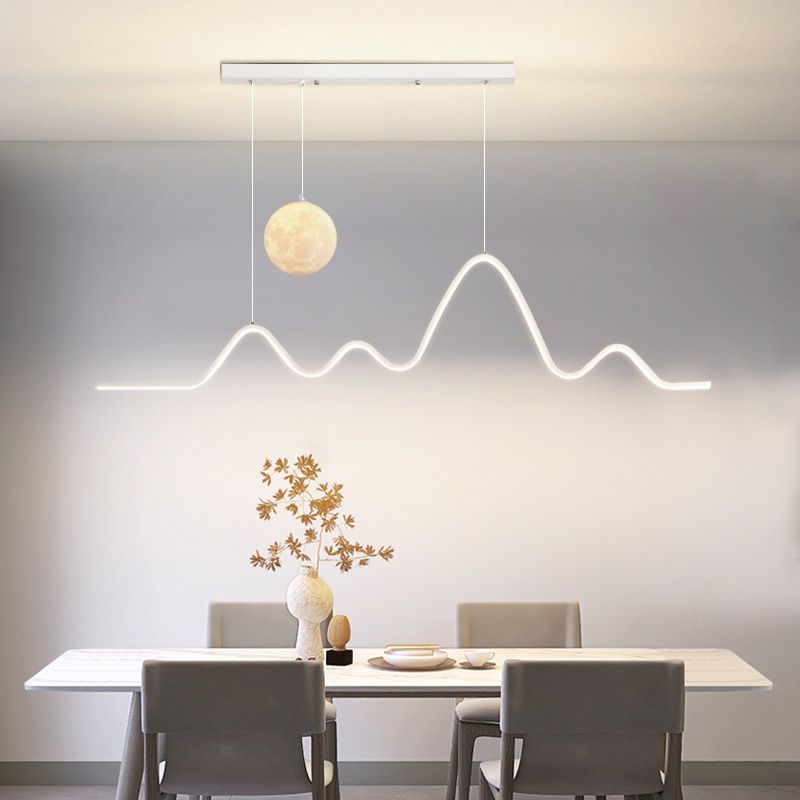 White wave pendant and globe over a long dining table