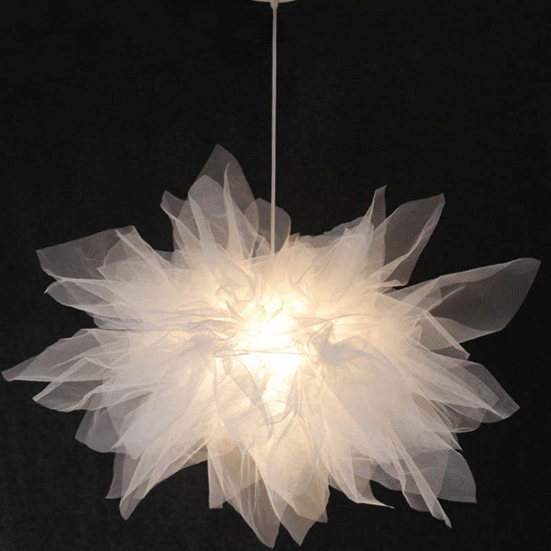 Close view of layered white fabric petals around Bella light