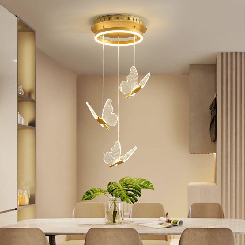 Three translucent butterfly lights suspended above dining table