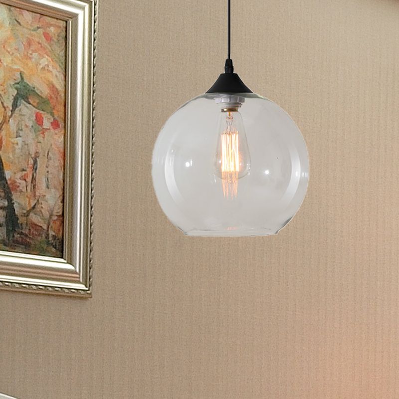 Clear glass globe pendant near framed wall art
