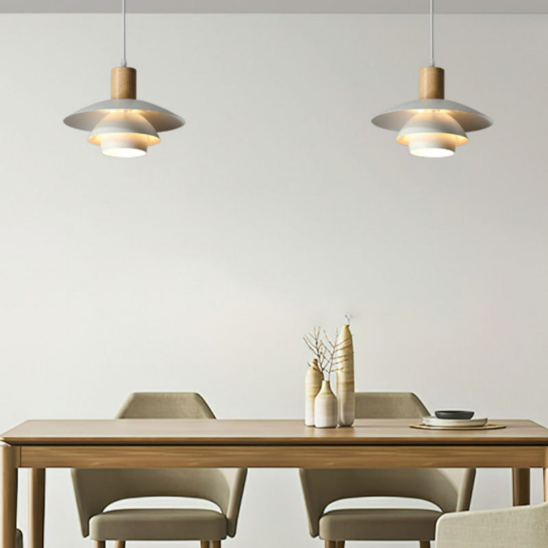 Two B tiered white pendants above dining table