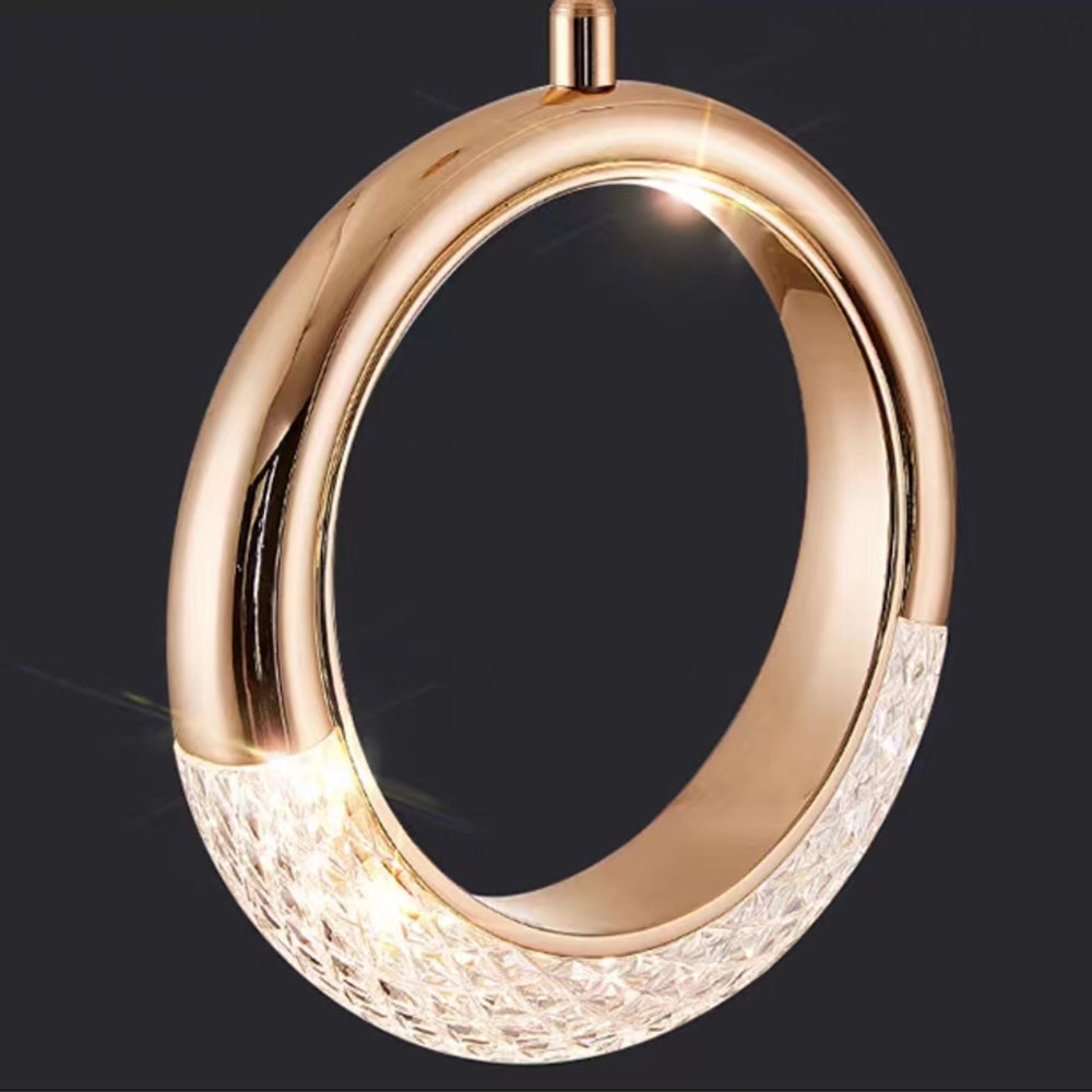 Angled close-up of a gold-tone circular frame with a luminous textured lower section