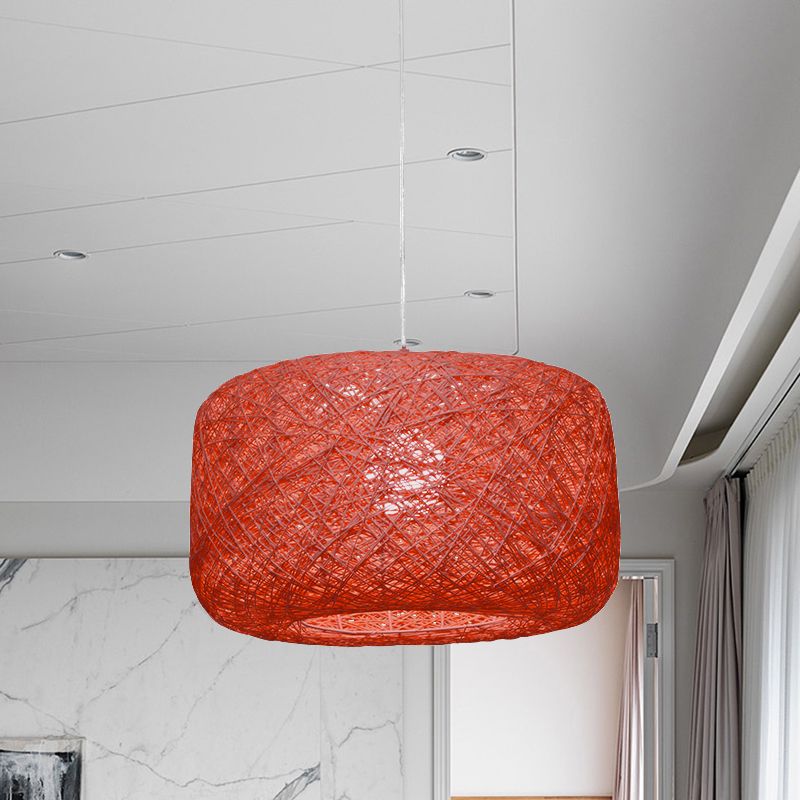 Deep red woven rattan drum pendant in pale room