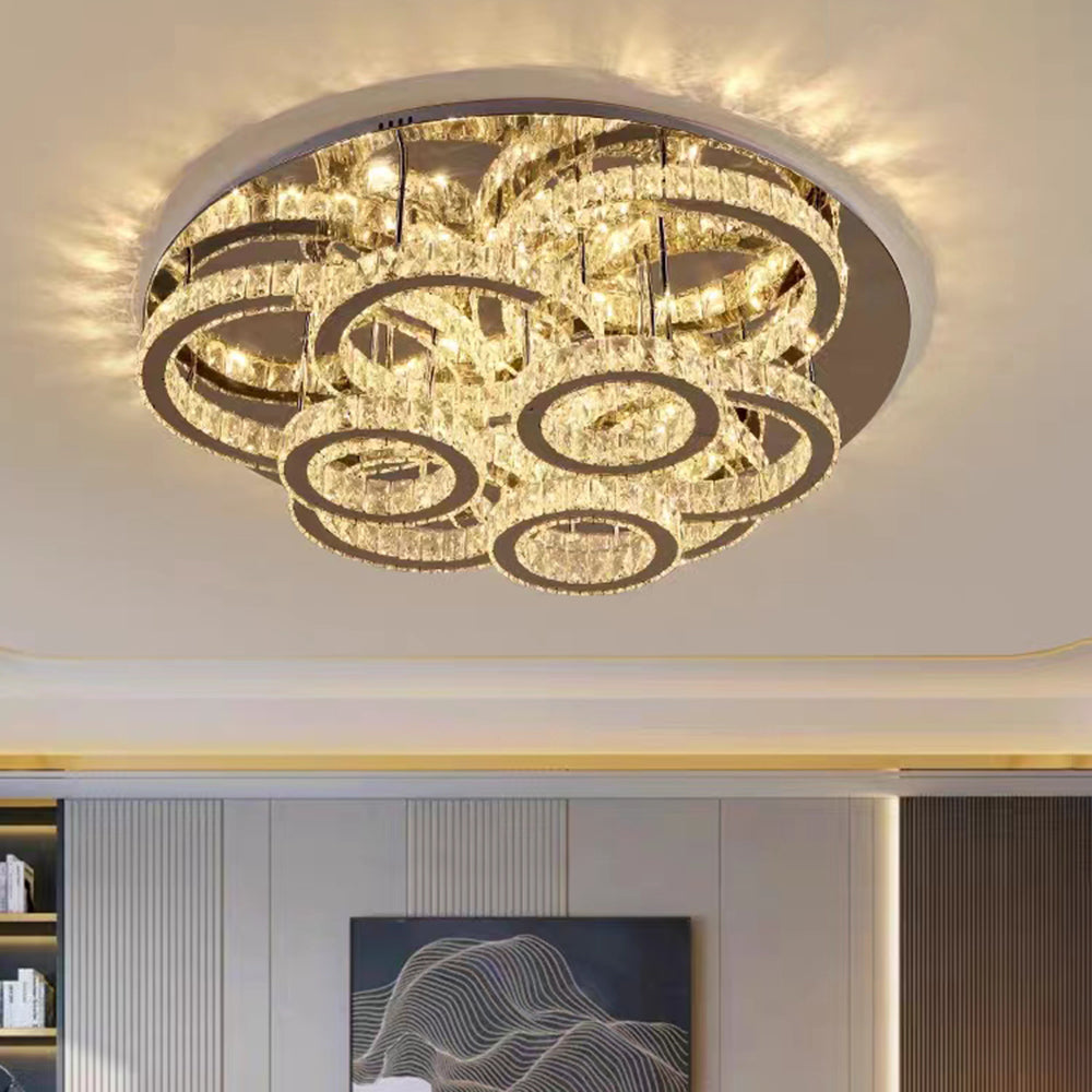 Low-angle view of Kristy layered circular crystal rings beneath the ceiling plate.