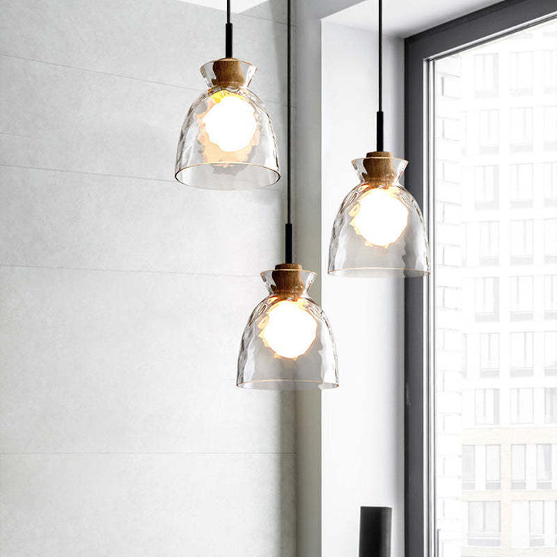 Three clear glass pendant styles beside a window