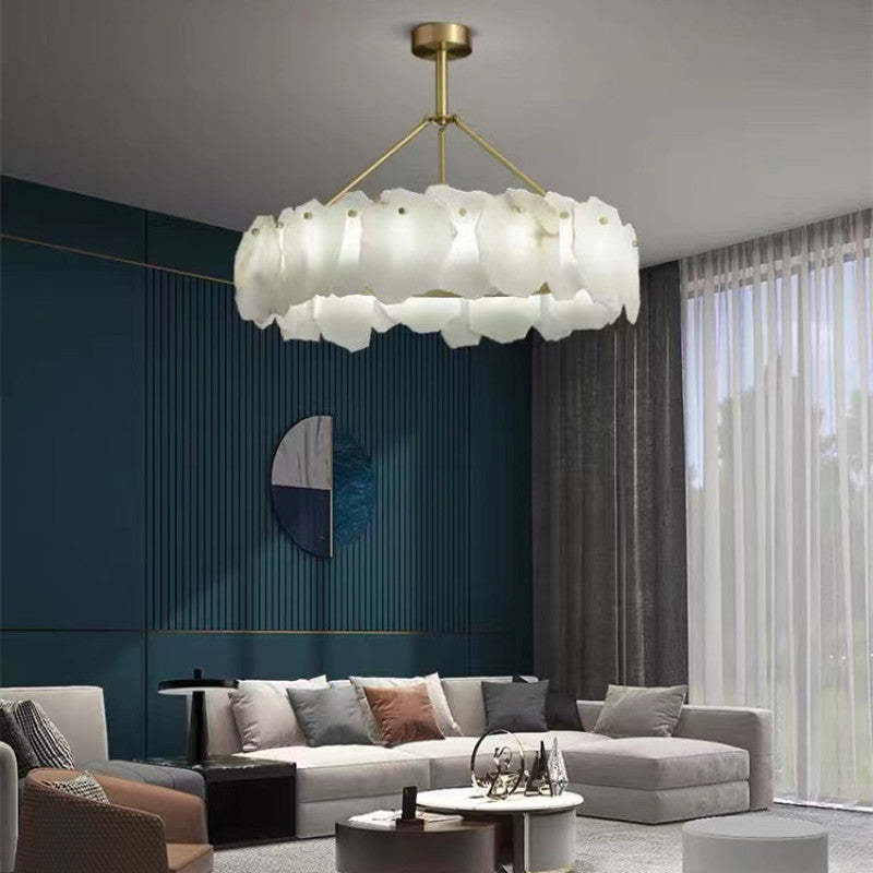 Marilyn round marble pendant in a blue-walled living room.