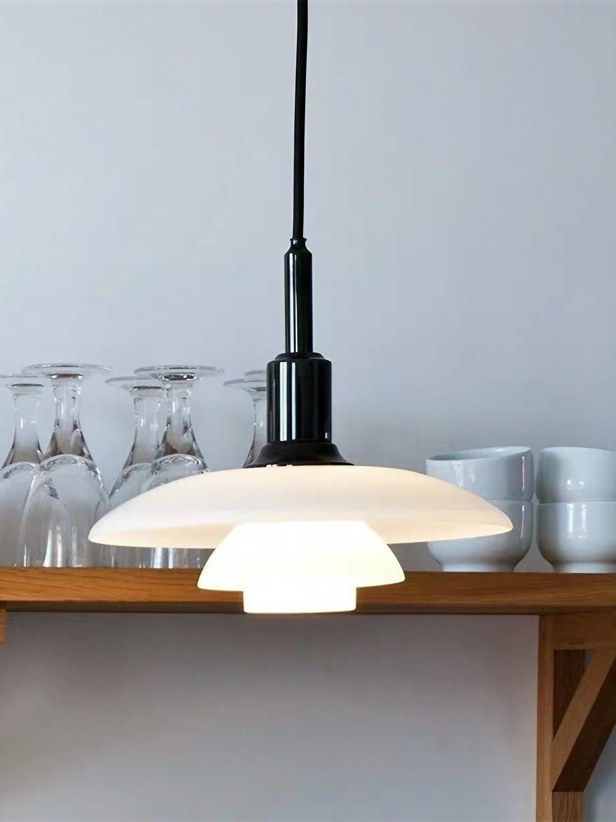 Close view of the layered opal disc shade and black upper fitting