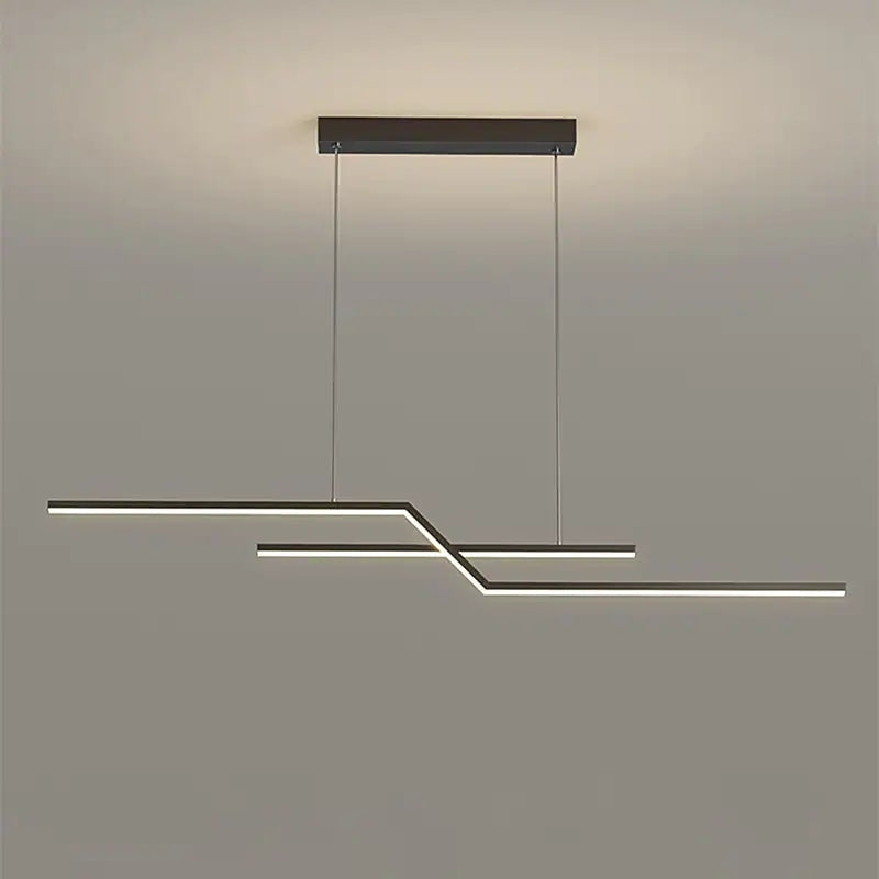 Black angular pendant against gray with continuous pale underside light faces