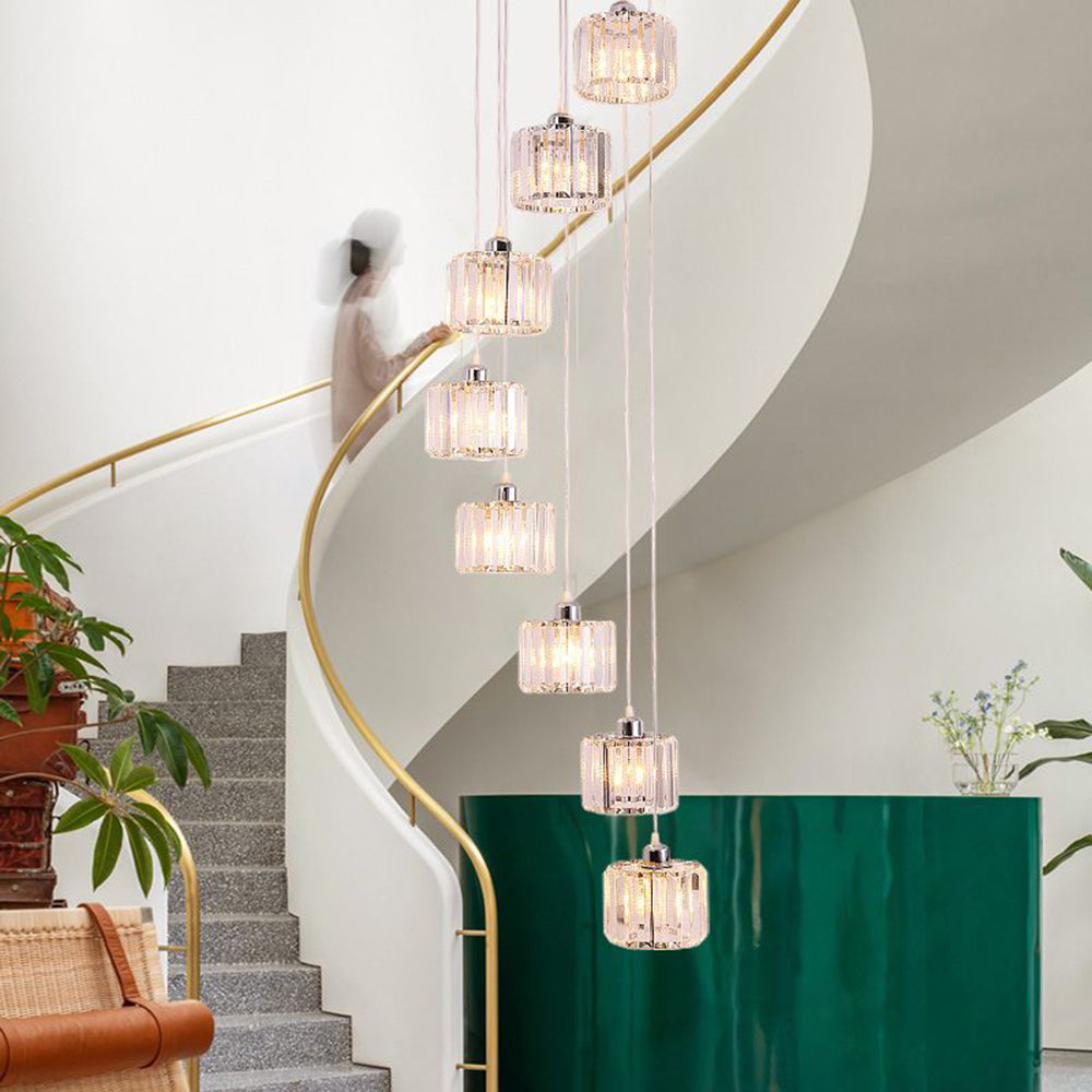 Cascading clear crystal column pendants beside staircase