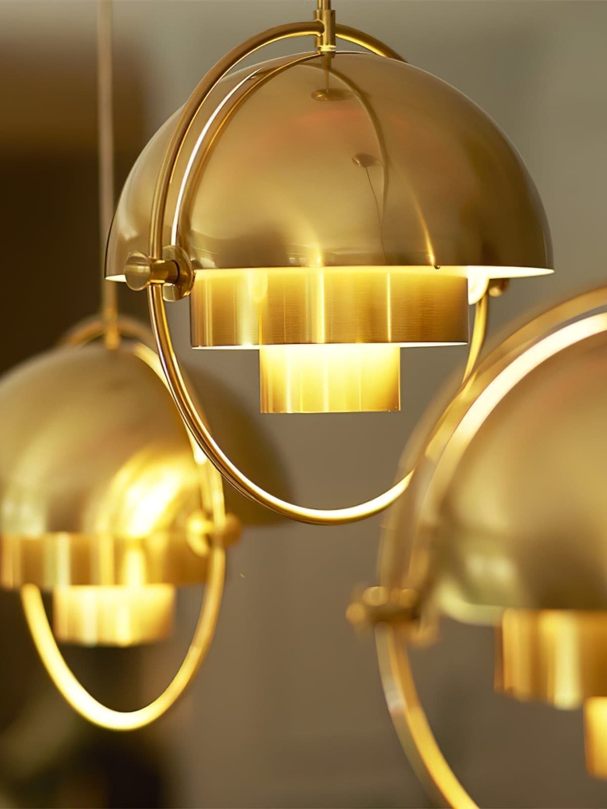 Close-up of illuminated copper-finish dome pendants
