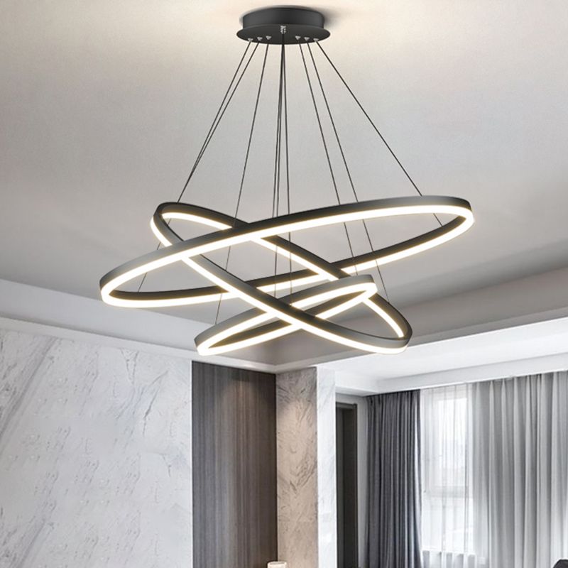 Three lit Arisha rings beneath a round canopy in pale-stone room