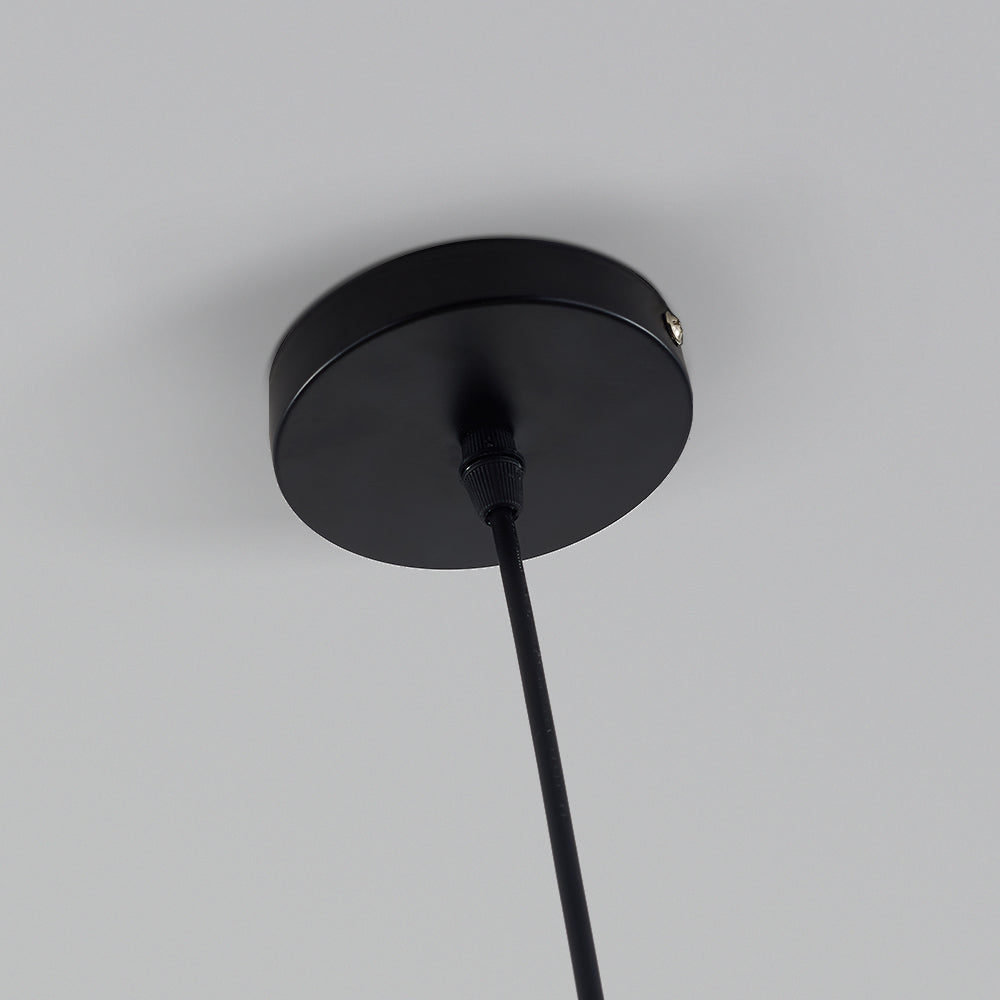 Close view of Morandi’s round black ceiling cap, side screw and single cord passing through a black gland