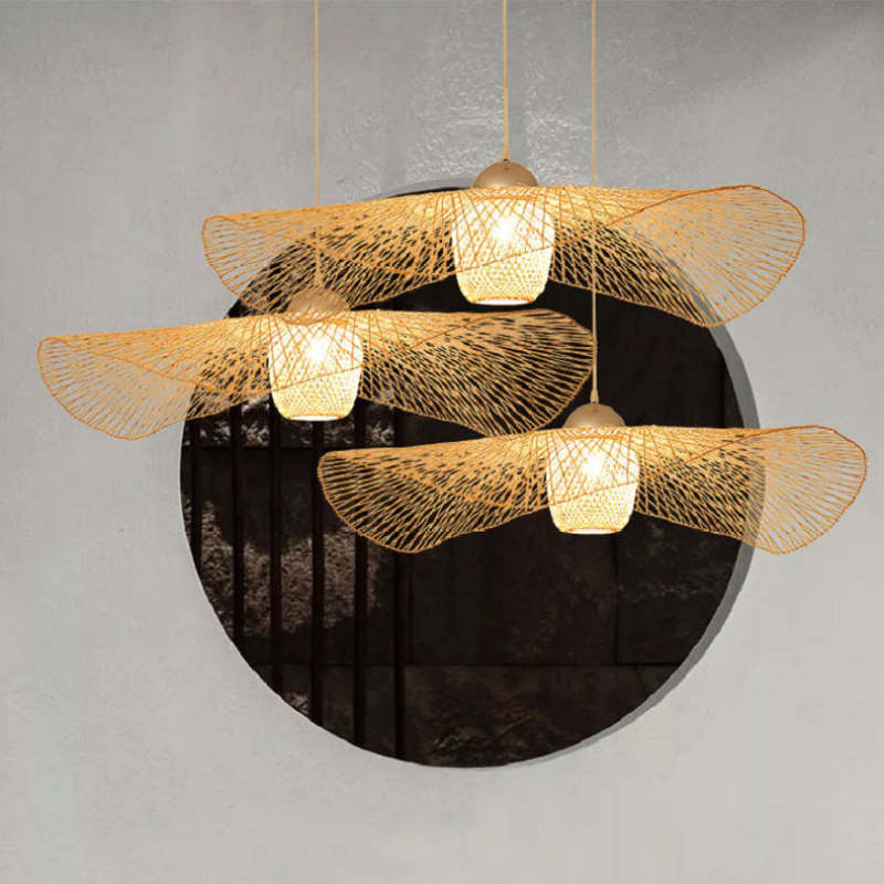 Three wavy woven pendants at different heights in front of a large circular window