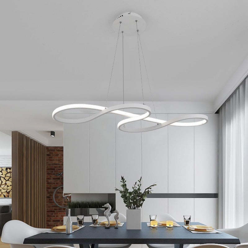 White crossing-loop pendant above a long dining table