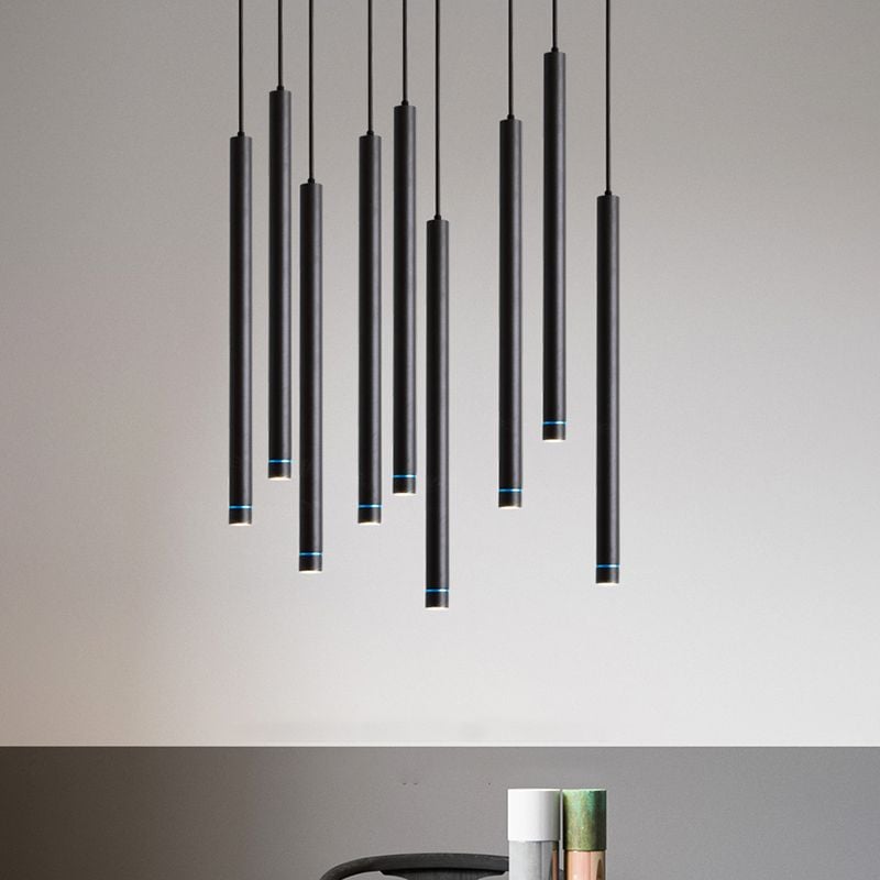 Black Edge tube pendants at staggered heights, with blue-looking rings near their lower openings