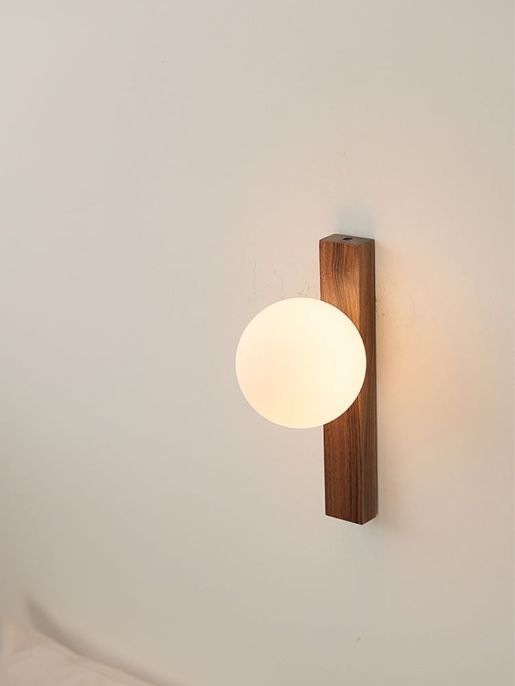 Angled view of the Lunaria globe in front of the walnut bar