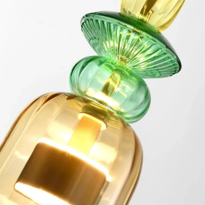 Green glass ring and long gold glass ornament close view
