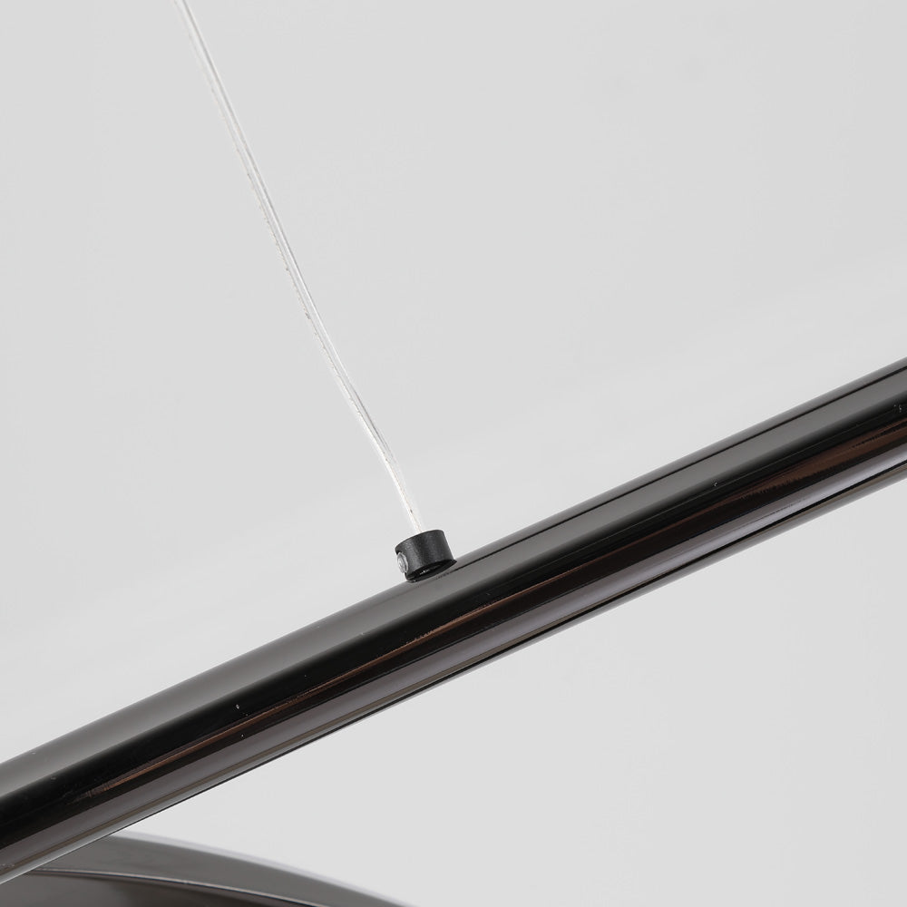 Clear suspension cord attached to black metal bar close-up