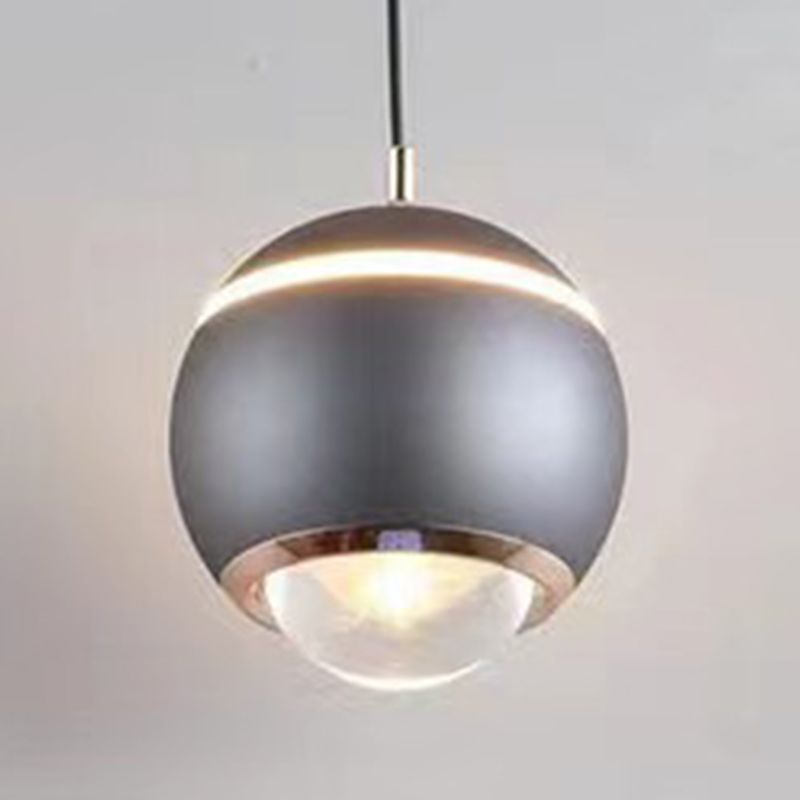 Grey spherical pendant close-up showing a lit upper band and clear lower dome