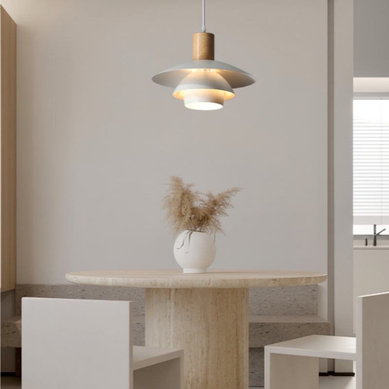 Single B white layered-disc pendant above small table