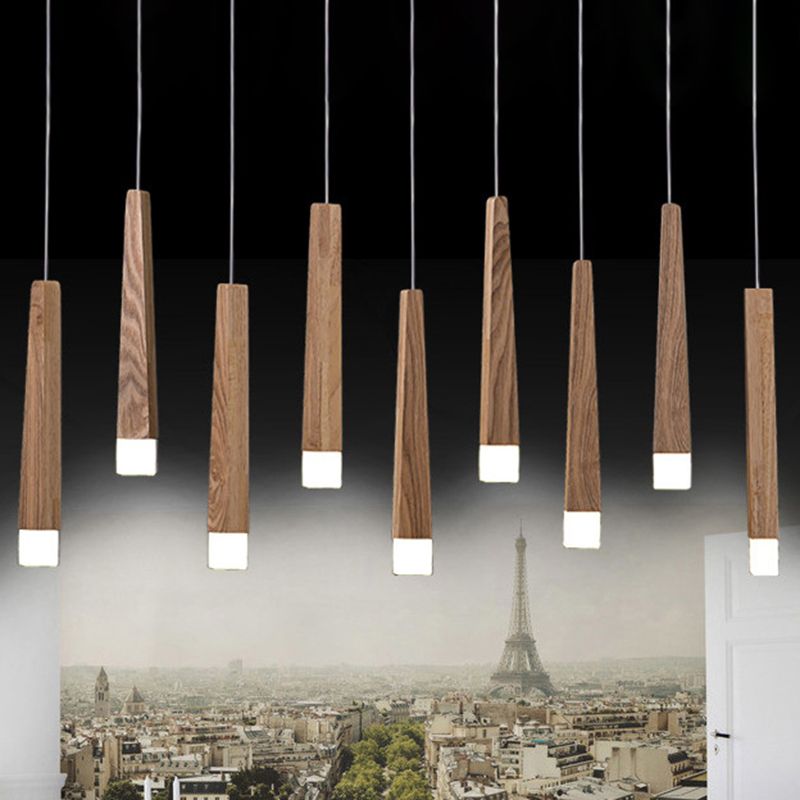 Staggered Ozawa wood column pendants above seating with a city-view mural in the background.