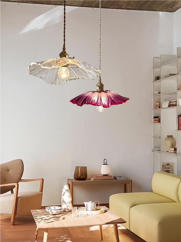 Pair of clear and purple lotus pendants in a furnished room