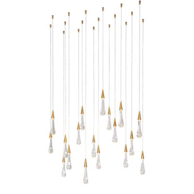 Many clear crystal drops with gold tops on a white background