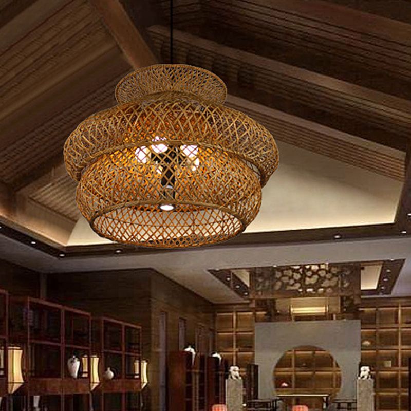 Large woven Ritta pendant hanging beneath a timber ceiling in a furnished room.