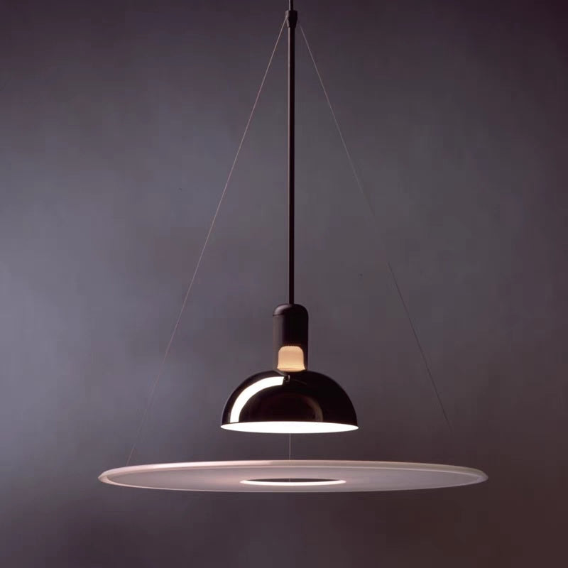 Dark reflective Levi dome above an illuminated white disc with a central opening against a plain dark background