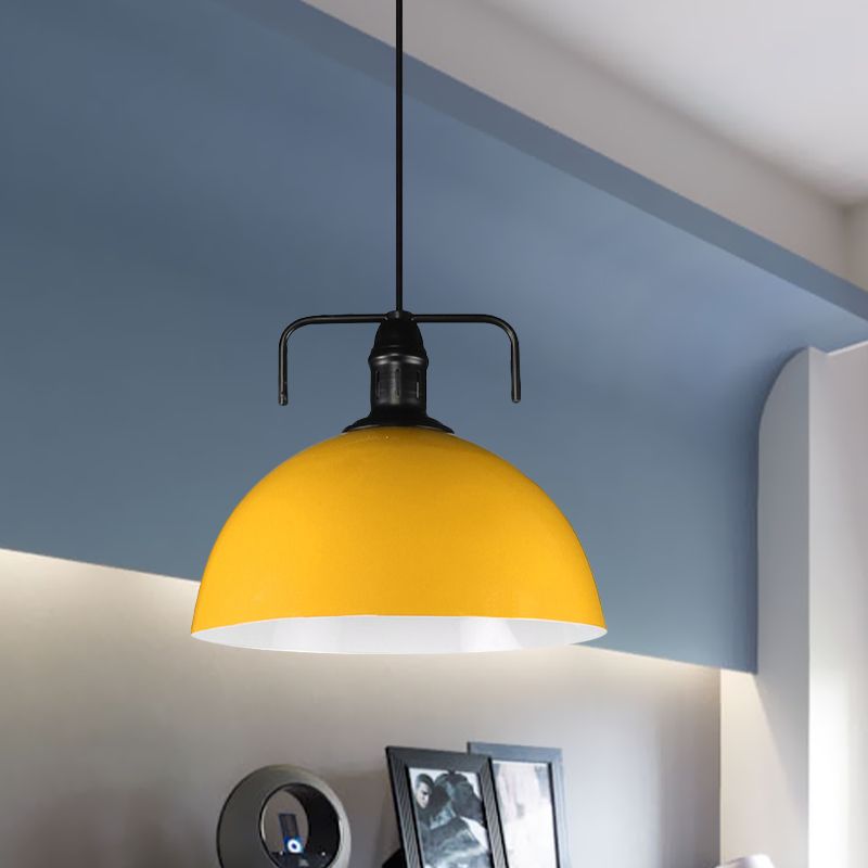 Yellow dome pendant against blue wall
