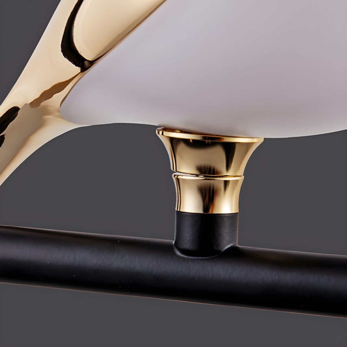 Close detail of gold-tone bird foot attached to dark ring