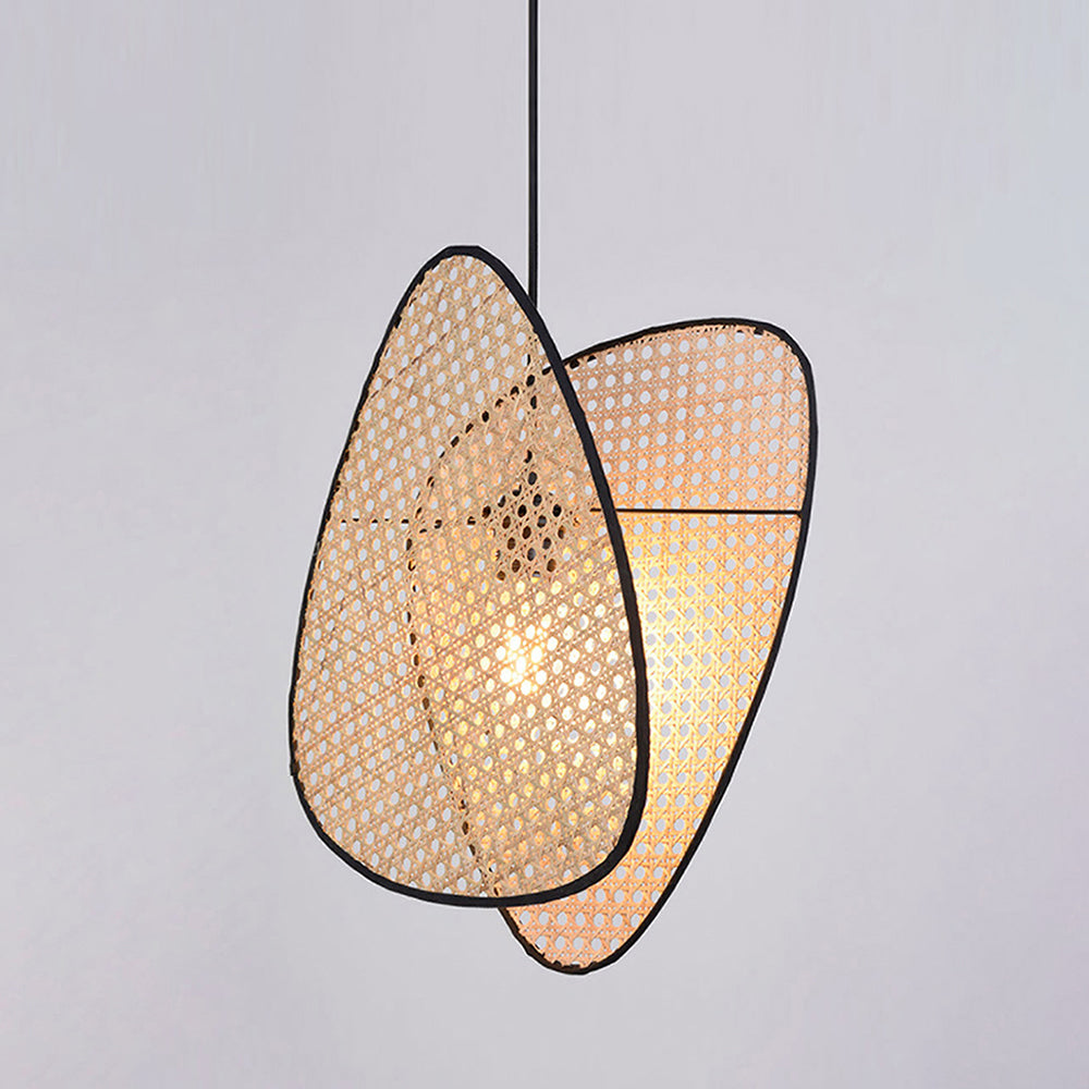 Illuminated Ritta pendant showing overlapping woven panels around the central bulb.