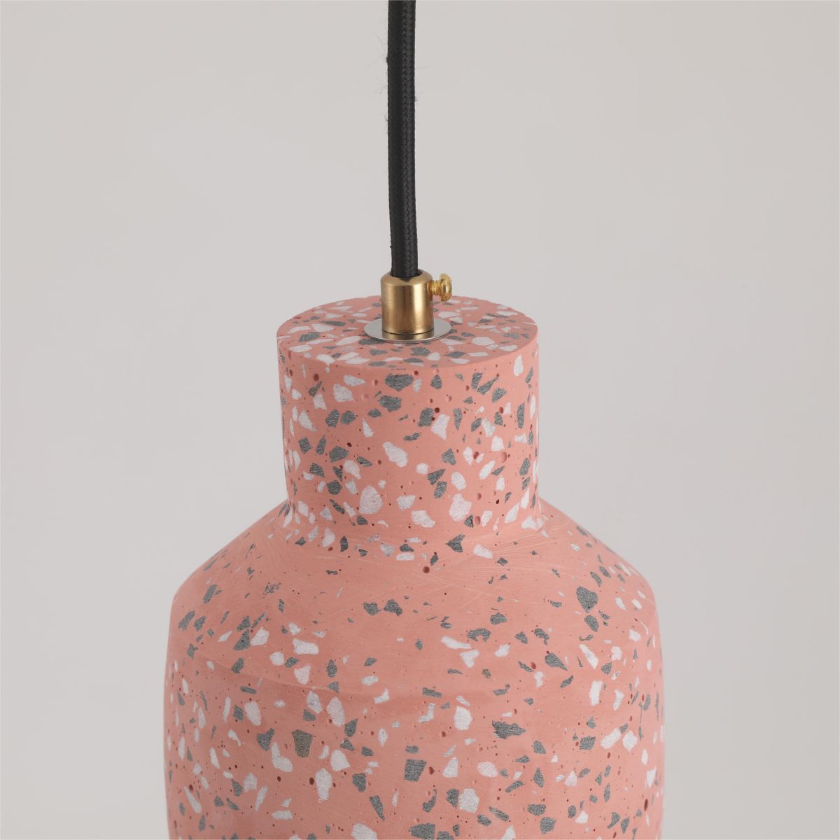 Closeup of Red Morandi’s speckled cement neck and shoulder, gold-tone cable grip and small retaining screw