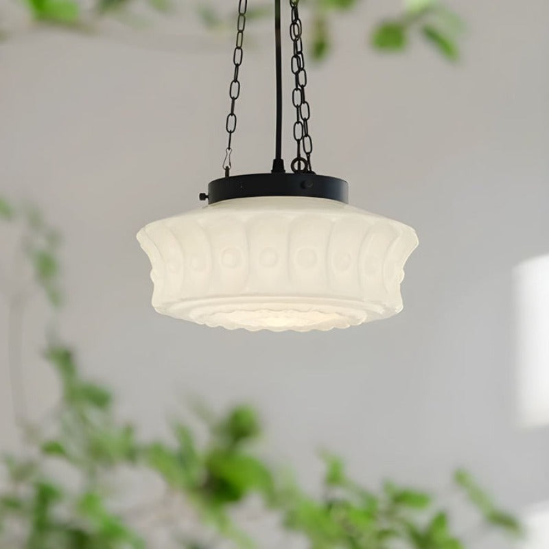 Raised circular motifs on pale glass shade close view