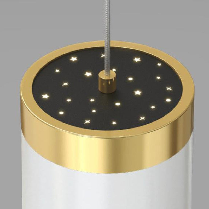 Close view of star-shaped apertures inside a gold-rimmed cylinder