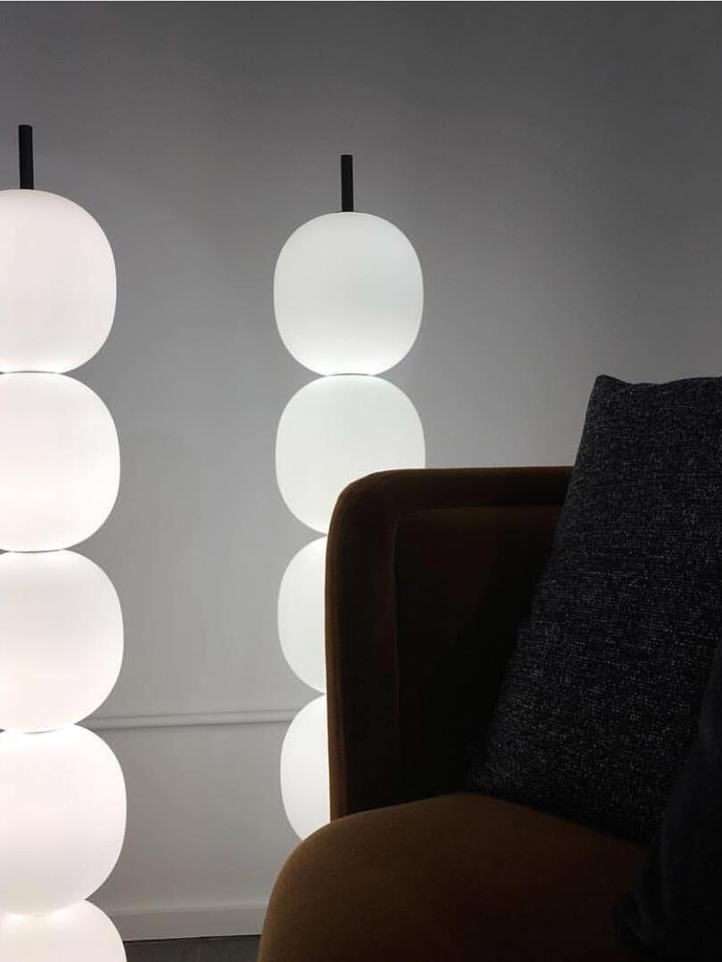 Illuminated globe lamps near a dark chair