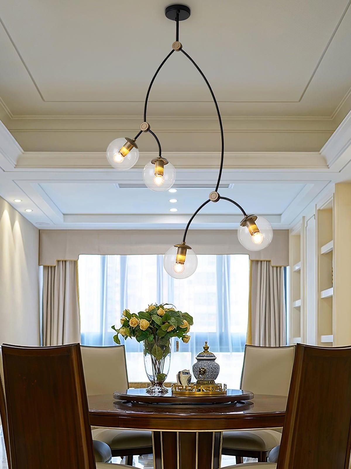 Tall four-globe chandelier above a dining table